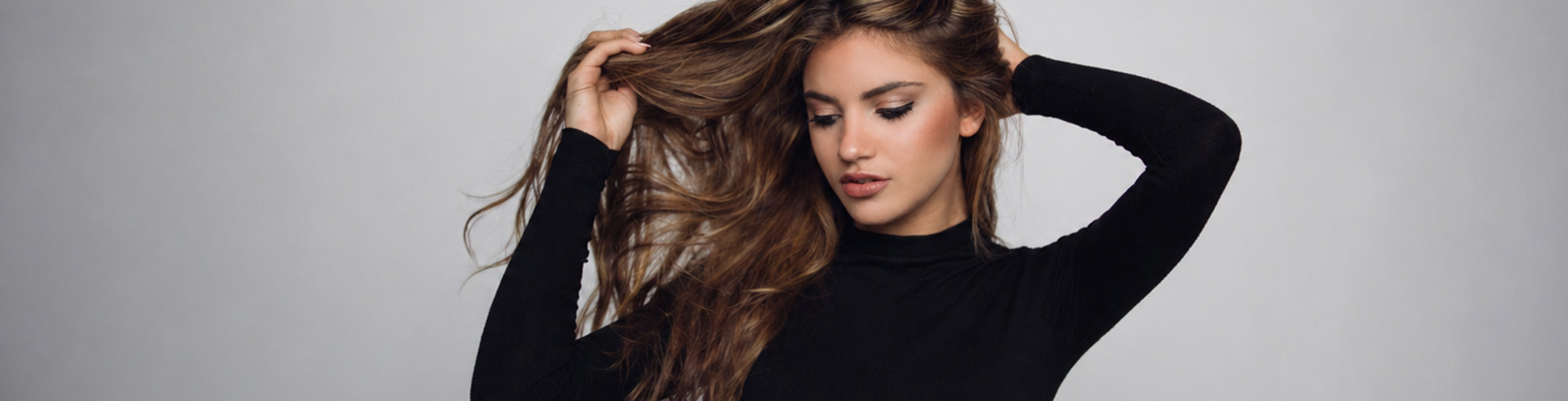 Woman with long, healthy-looking brown hair, illustrating the results of permanent hair colour.